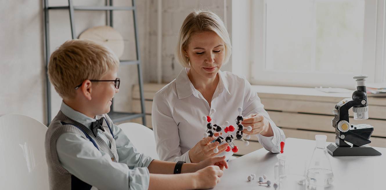 Female science tutor in Winston-Salem studying chemistry with student