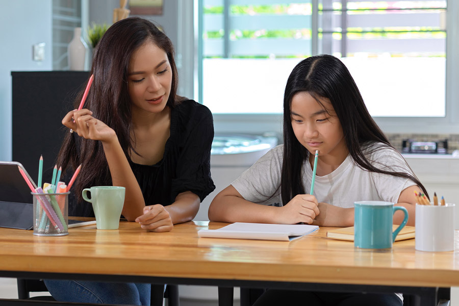 student and tutor together at a desk in Winston-Salem